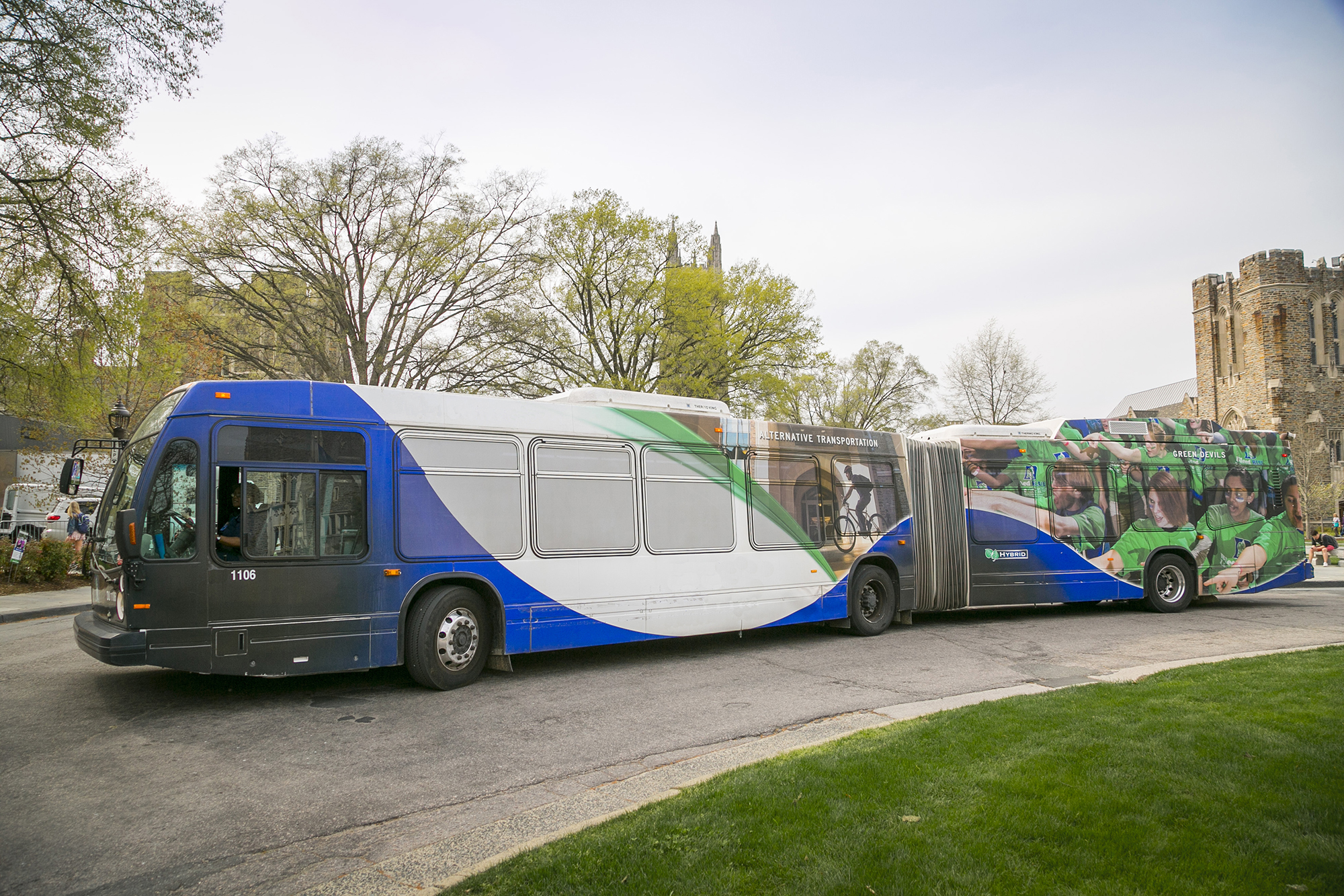 New double length articulated bus pulls up to pick up students
